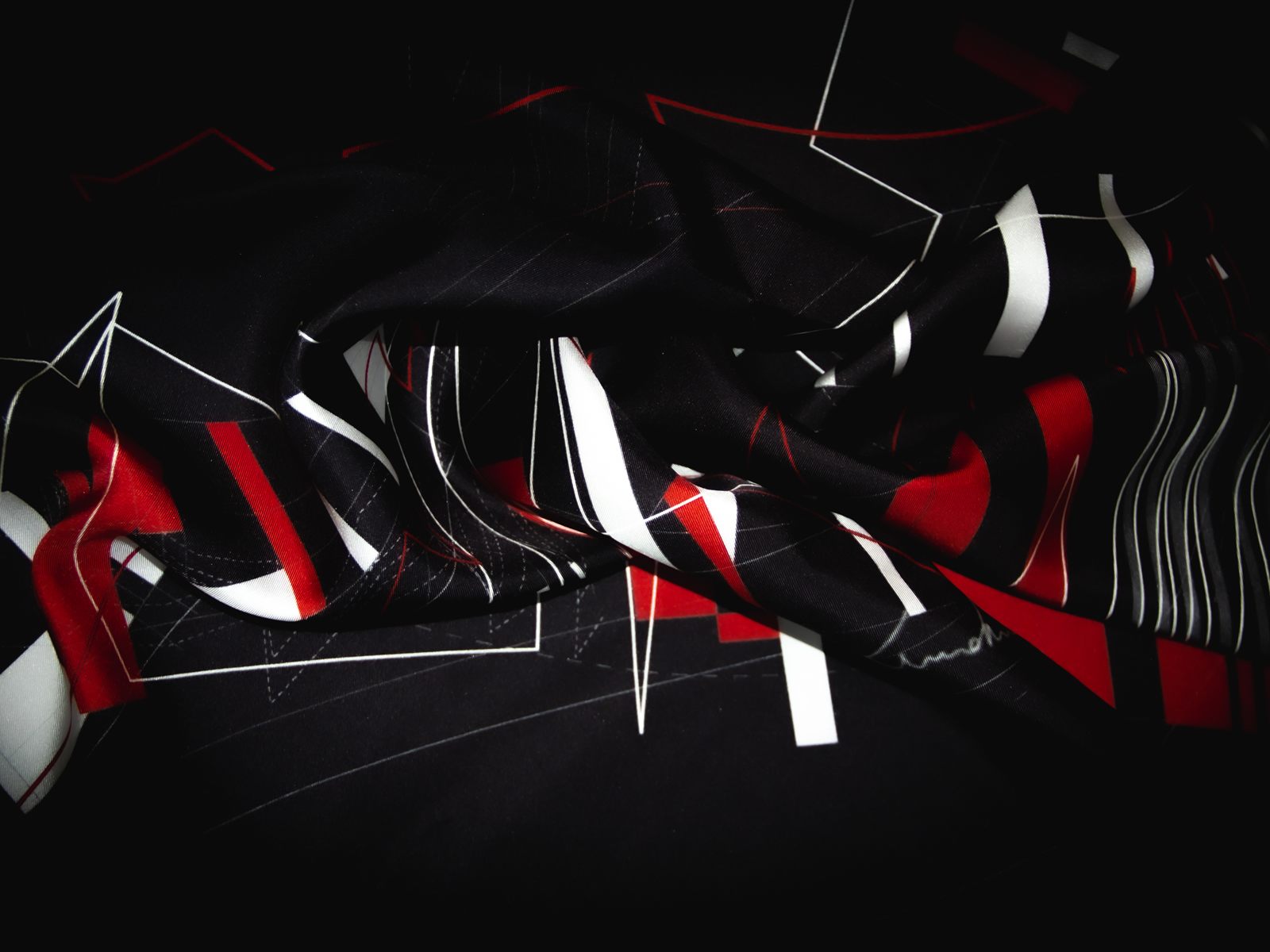 Unfold New York — Black silk scarf, draped: red, white and black fragments over night-black twill