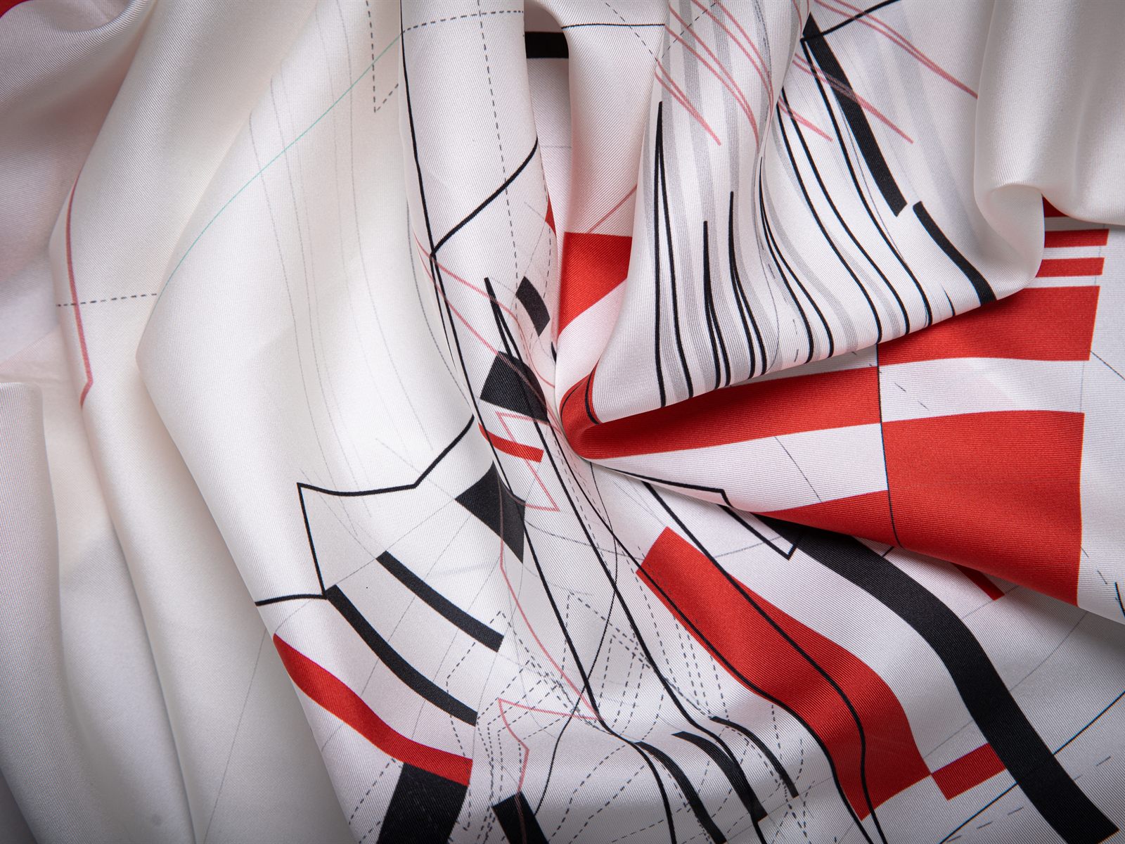 Unfold New York — White silk scarf, draped: crimson blocks and black linework across paper-white twill